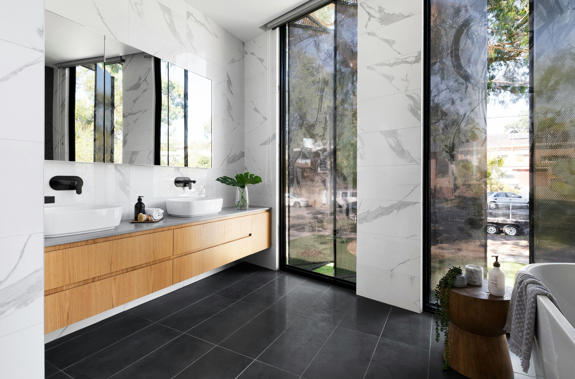 Empty reception of a modern and luxurious hotel with marble floor and walls, decorated with minimalist furniture and warm lighting